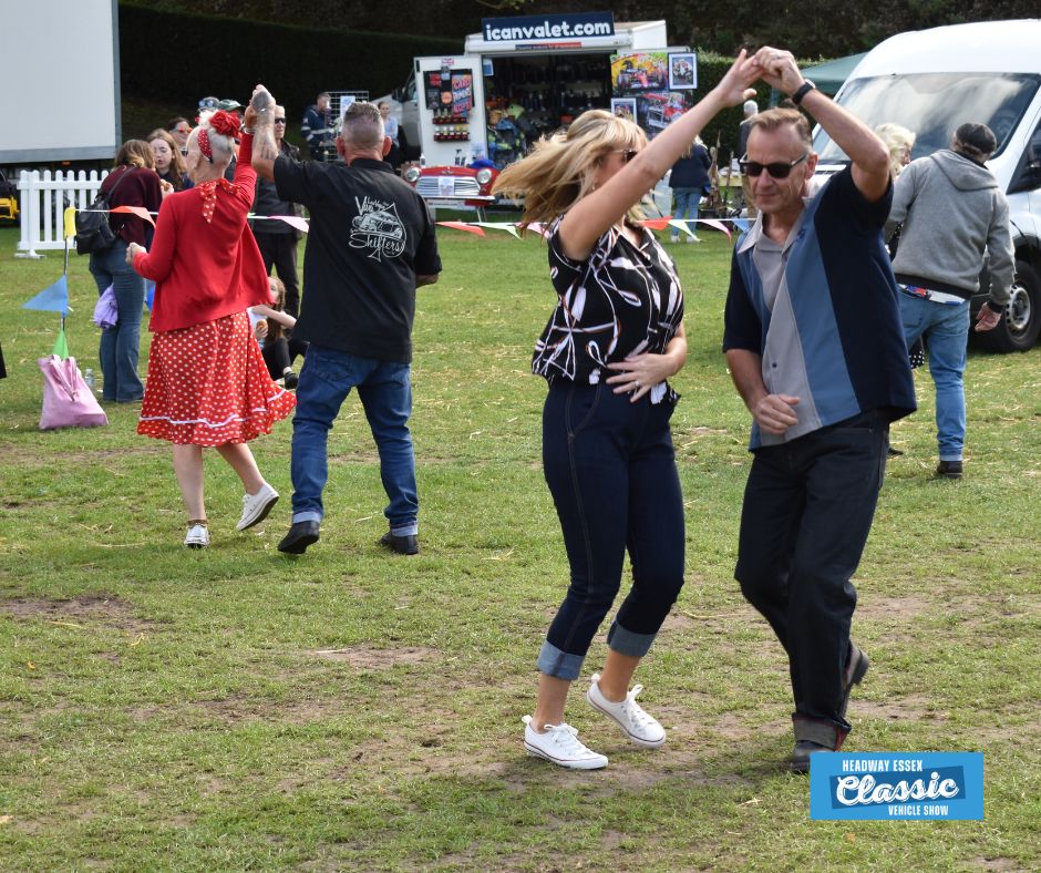 Image shows a man and a woman dressed in 1950's style clothing dancing