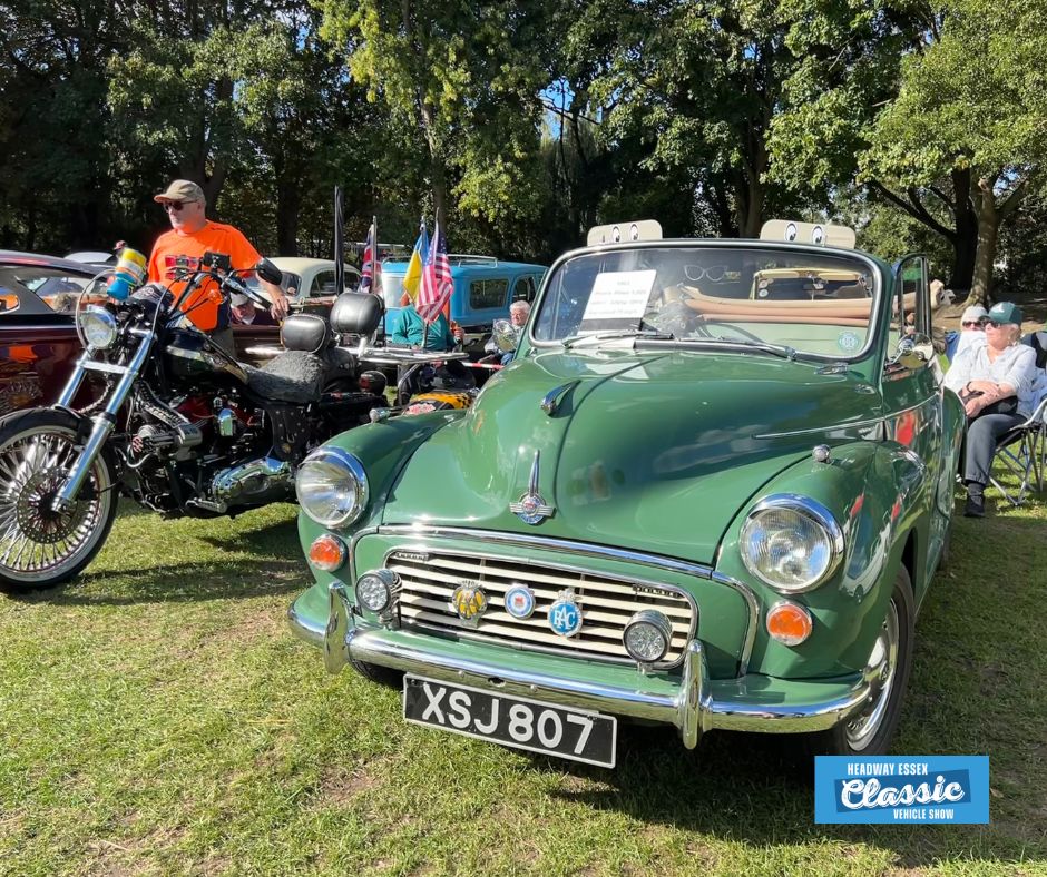 Image shows vintage green car and black motorbike